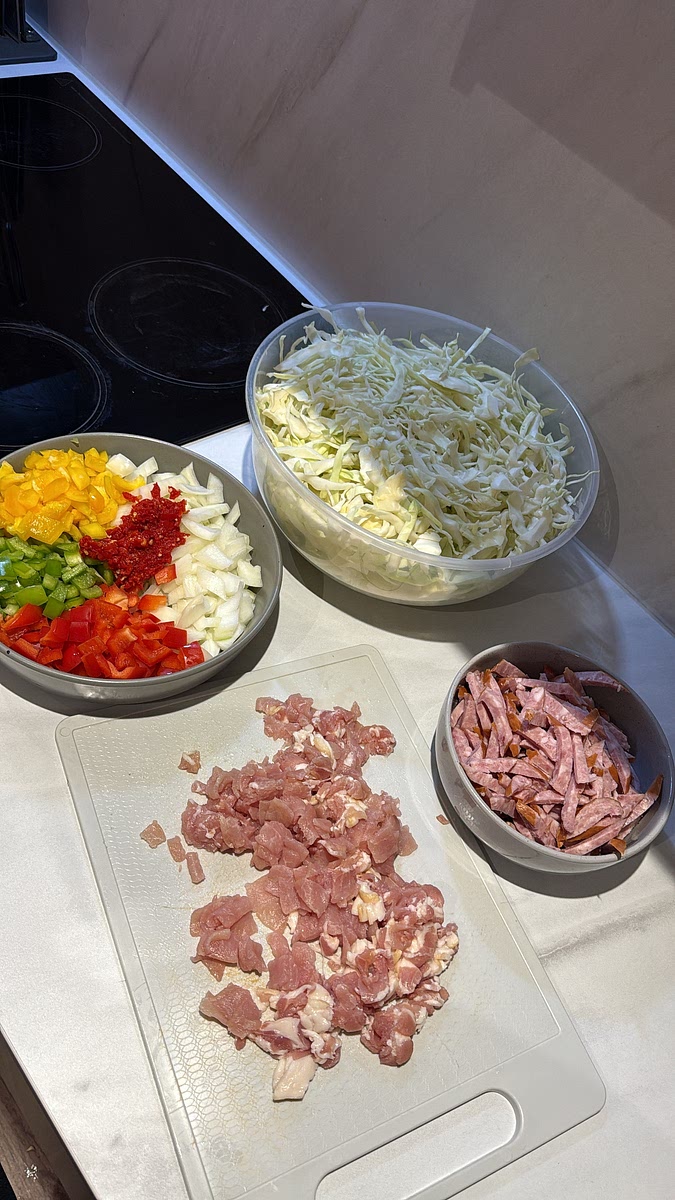 Chop the bacon into small pieces and slice the sausage into thin strips.