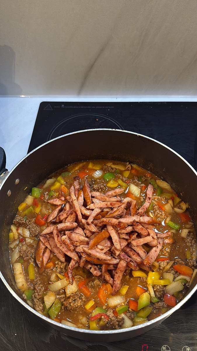 Add the cooked sausage back into the pot and stir it through the beef mixture.