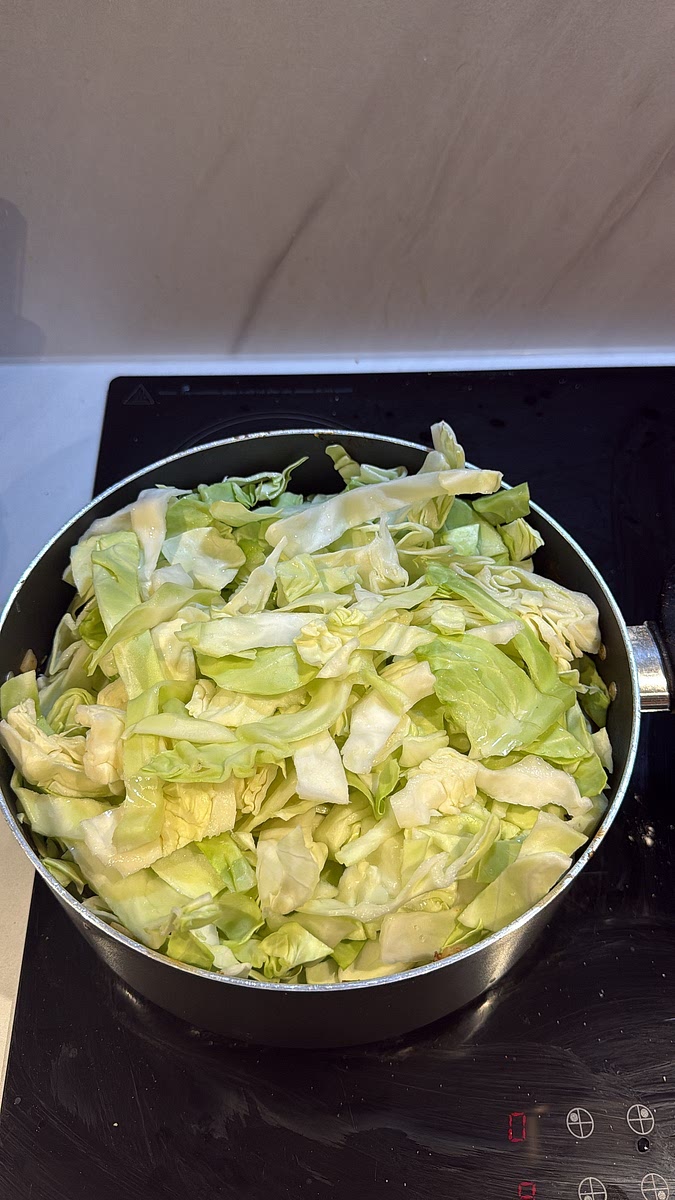 Pile the chopped cabbage into the pot. It will look like way too much at first, but trust the process! Cover and leave it to simmer — the cabbage will wilt dramatically as it cooks.