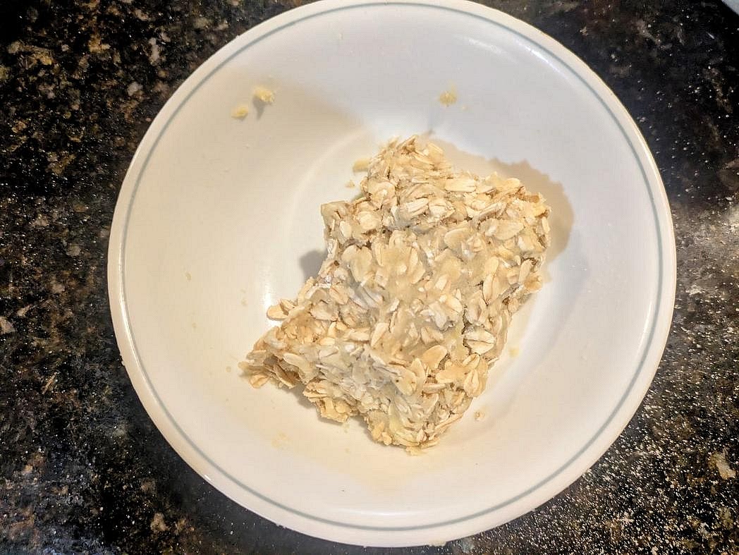 In a bowl, combine together the crust/crumble ingredients - mashed banana, vanilla, liquid monk fruit, coconut flour, and rolled oats. Mix until well combined with a silicone spatula.