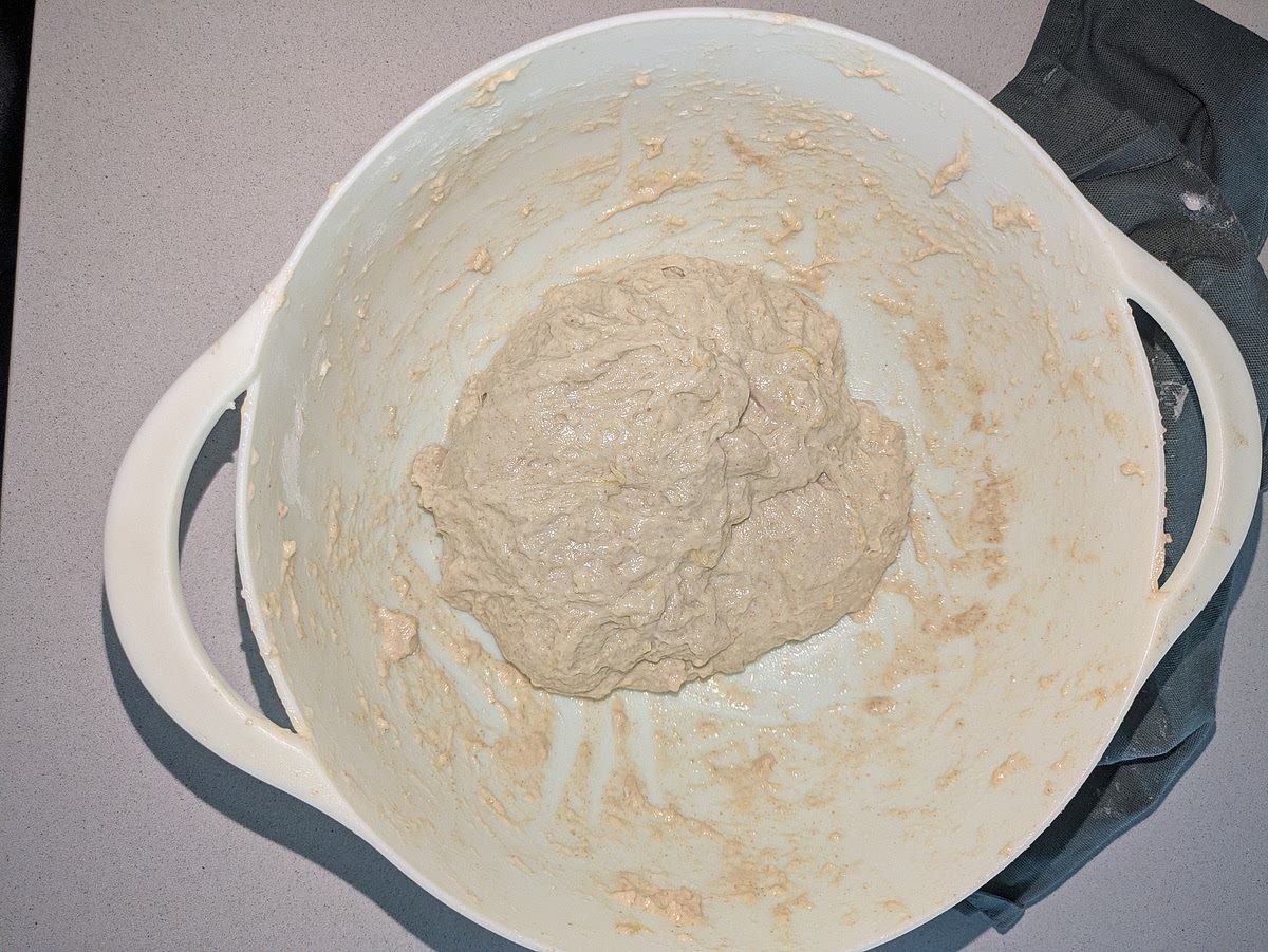 Incorporate Fats, Sugar & Salt
Add 60g Greek yogurt, 30g softened butter, 1 tbsp brown sugar, and 10g salt directly to the autolysed dough.
Squeeze, dimple, and fold the dough continuously for 3 to 5 minutes. The mixture will feel slippery initially, but as you knead, the gluten will absorb the fats, transforming into a smooth, glossy dough. Rest covered for 30 minutes.