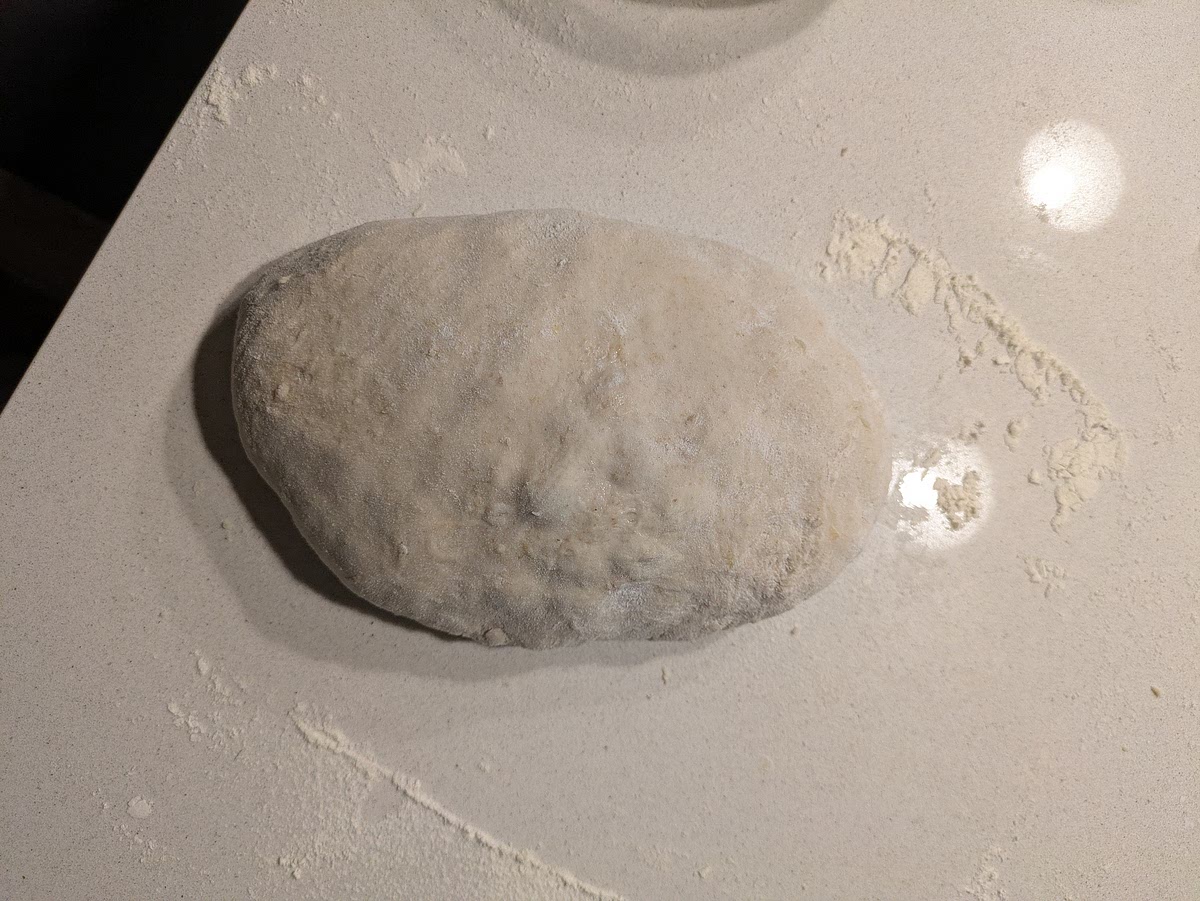 Bulk Fermentation
Cover the bowl and let ferment at room temperature.
Watch for visual cues rather than clock time: proceed to shaping only when the dough has expanded by roughly 50% in volume, shows domed edges, and feels soft, airy, and jiggly to the touch.