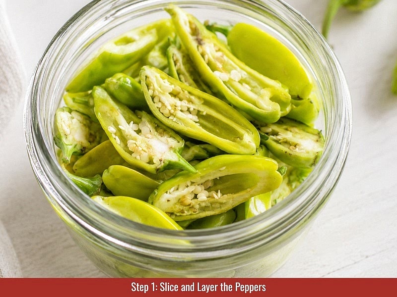 Slice and layer the peppers: Cut fresh pepperoncini peppers in half lengthwise. Remove some pale inner tissue for a milder sauce or keep it intact for more heat. Layer the peppers, sliced onion, and whole garlic cloves into a clean 1-quart Mason jar.