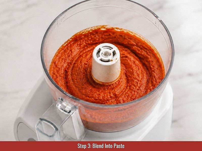 Blend into paste: Turn on the food processor and slowly add extra virgin olive oil while blending. Scrape down the sides and continue blending until the mixture becomes a thick, slightly chunky paste. Adjust salt or cayenne according to taste.