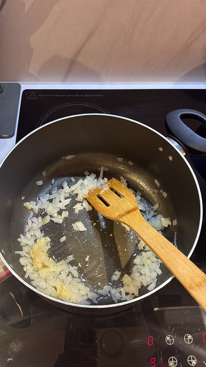 Add the garlic and cook for around 30 seconds before stirring in the tomato purée.