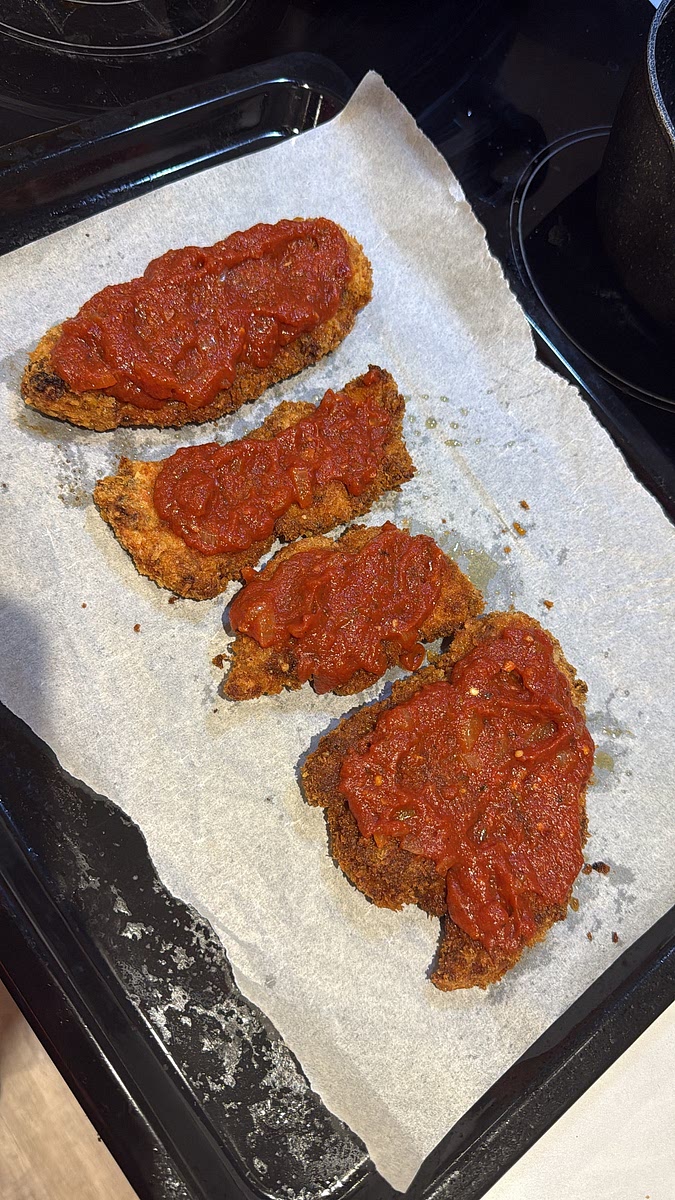 Spoon a small amount of the reserved tomato sauce over the centre of each cutlet — don’t completely drown the crispy coating.