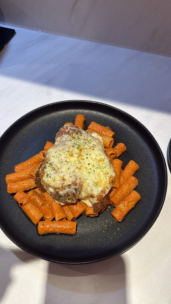 Top generously with mozzarella followed by Parmesan. Place under the hot grill for approximately 2–4 minutes, watching closely, until the mozzarella is melted, bubbling and beginning to turn golden. Finish with freshly grated Parmesan, basil or parsley and a little chilli flake.