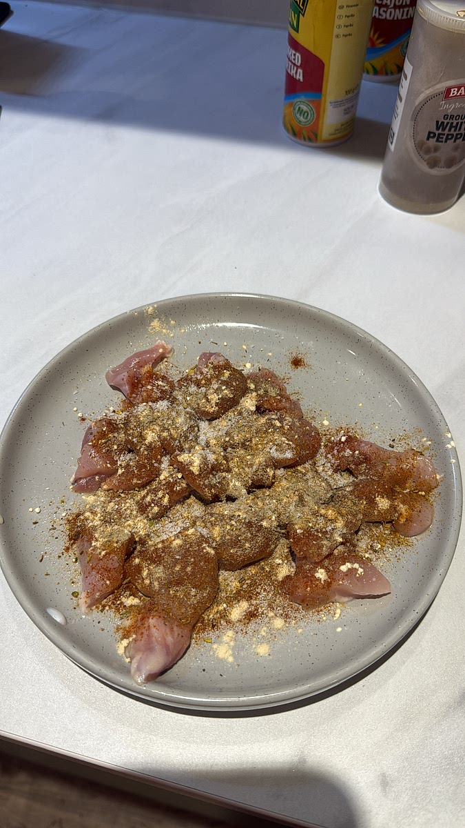 Cut that thigh into bite-sized pieces. Season with paprika, garlic, onion, Cajun seasoning, pepper and salt.