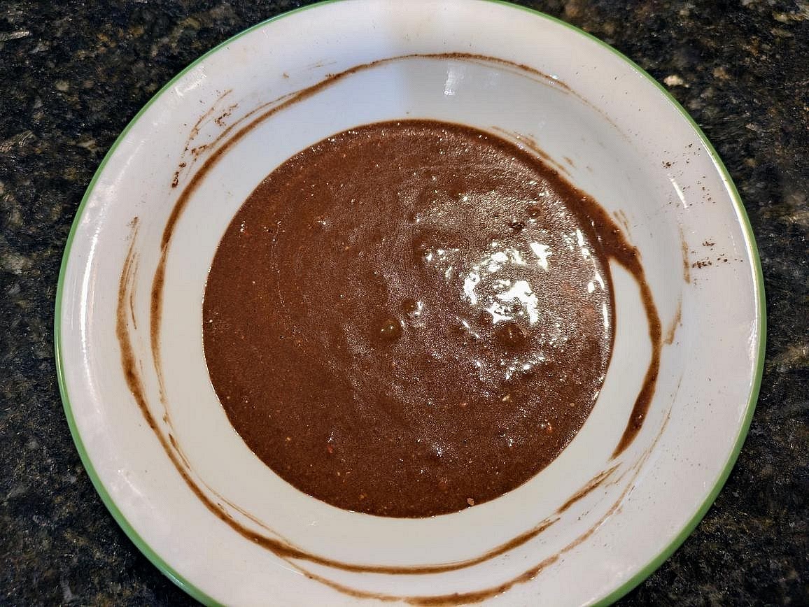 Add almond butter, cocoa powder, vanilla extract, and sugar free syrup to a medium bowl. Mix until fully combined with a silicone spatula. Set your frosting aside.
