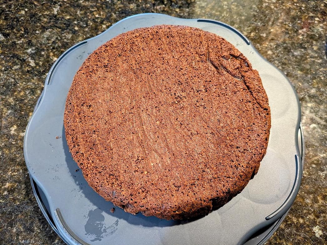 Place your first cake layer upside down on the plate, so the flatter side faces up.