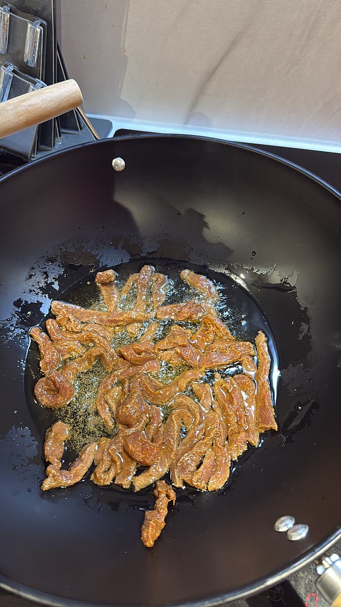 Get a wok or frying pan really hot with a small drizzle of oil. Spread the beef out in one layer and leave it alone for around 45–60 seconds so it actually browns rather than steams. Toss and cook for another 1–2 minutes, depending on how thin you’ve sliced it.