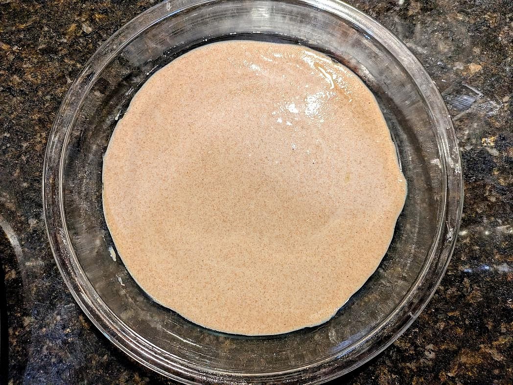 Add your starter directly to the pan with baking powder and salt. Mix together with a silicone spatula until fully combined. Smooth out to a bottom pie crust. Note that this will not go up the sides, just the base.