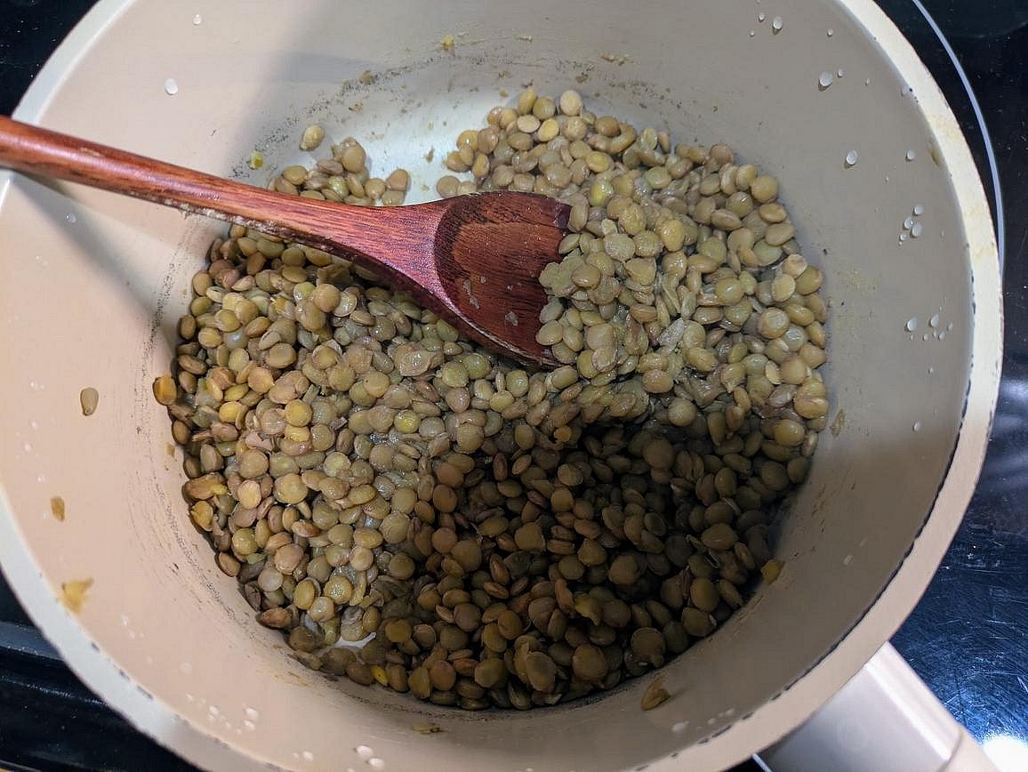 Add lentils and water to a small pot, covered. Bring to boil over high heat, then reduce heat to low. Simmer with the cover on for about 25 minutes, or until the lentils are soft enough to smash them between your fingers. Remove from heat and let them cool for about 15 minutes.