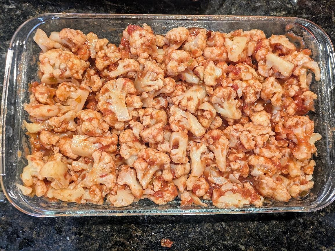 Directly in a large casserole dish, add your cauliflower and salsa. Mix together.
