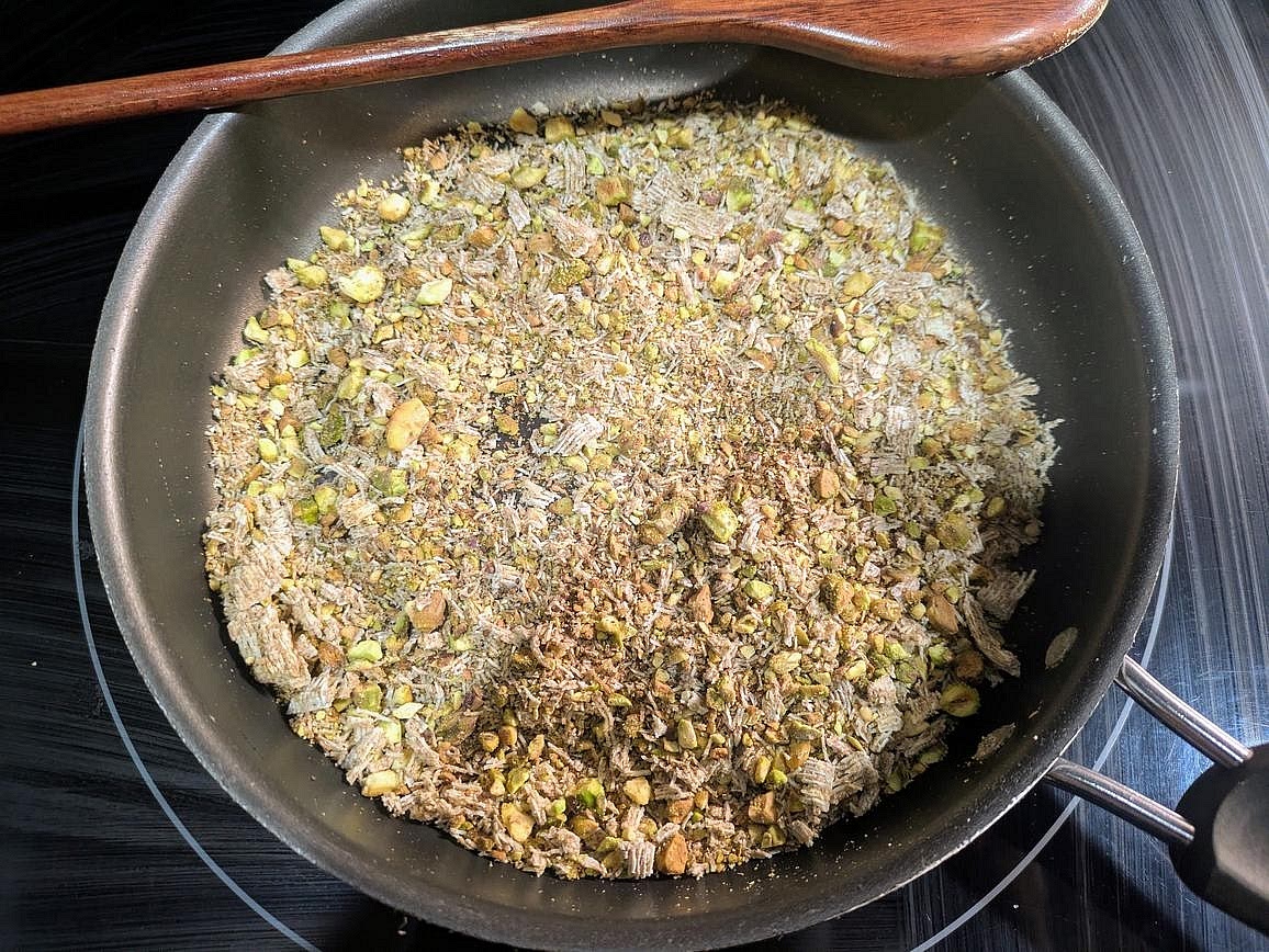 Roughly chop your shredded wheat cereal and pistachios, and add them to a dry, medium pan. Toast over medium heat for about 5 minutes, or until lightly browned and fragrant. Set aside to cool.