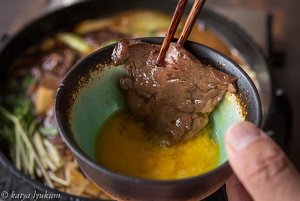 Transfer cooked sukiyaki to individual bowls with beaten eggs. Eat hot with a bowl of Japanese rice on the side.