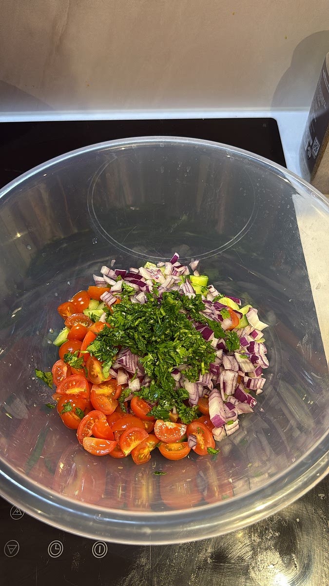Combine the diced cucumber, cherry tomatoes, sliced red onion, bell pepper and fresh parsley in a large bowl.
