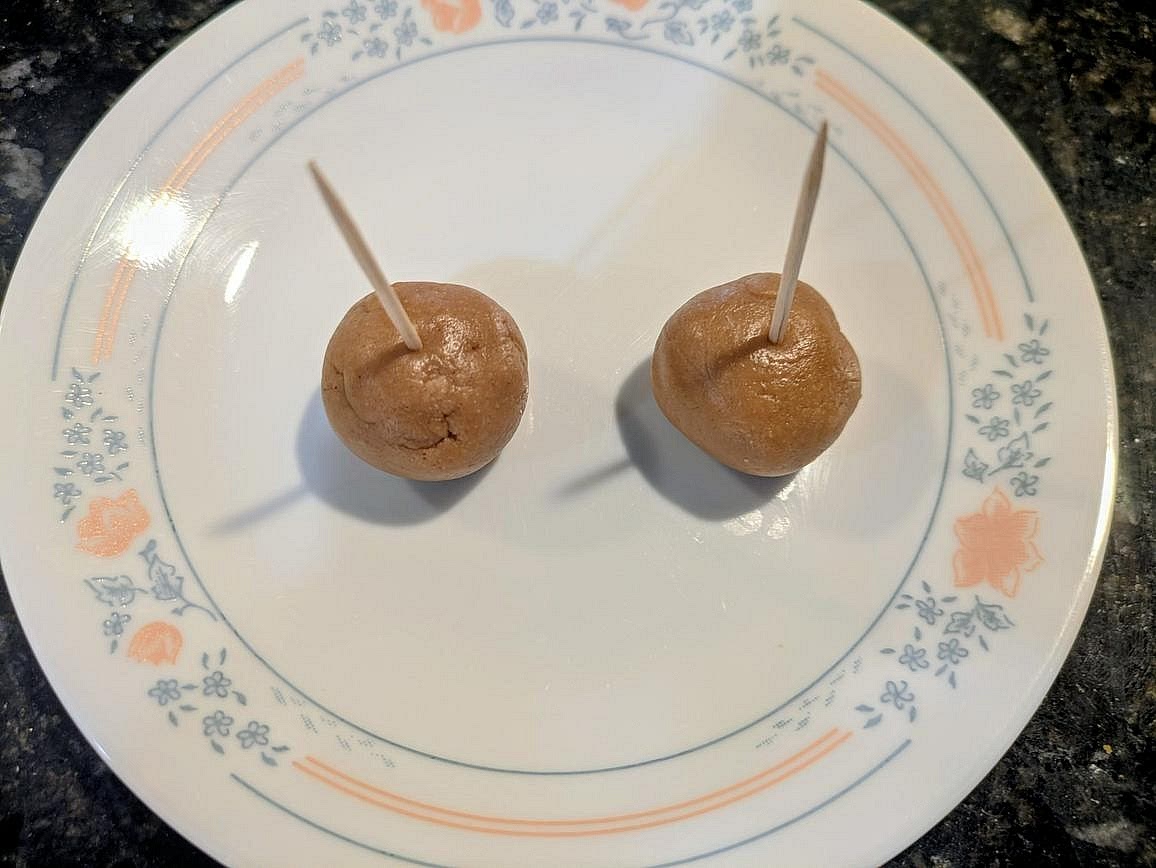 Divide the dough into 12 equally sized pieces, about 16 g each. Roll into a ball, and place onto a plate. Stick a toothpick into the top of each one.