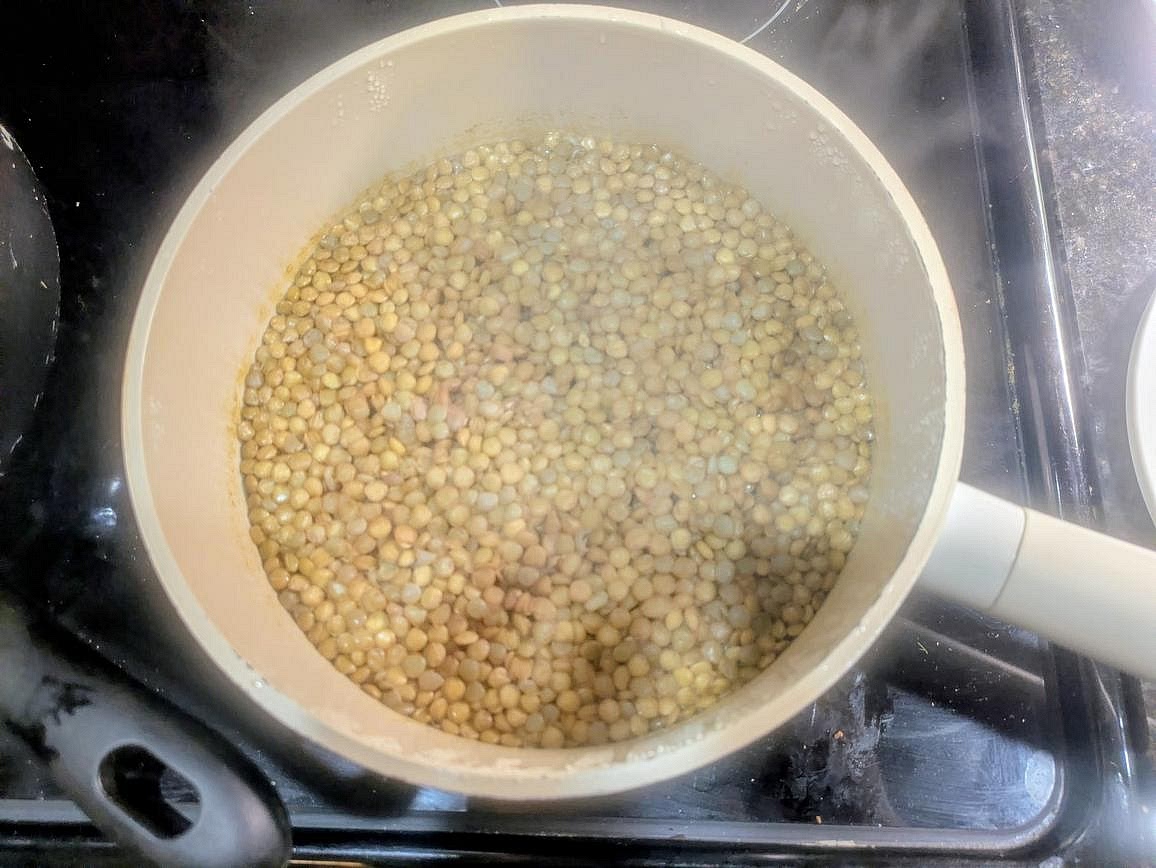 Add lentils and broth to a medium pot. Cover and bring to a boil over high heat. Reduce heat to medium low, and let simmer (covered) for about 30 minutes, or until all the water has been absorbed. Transfer the cooked lentils to a large slow cooker.