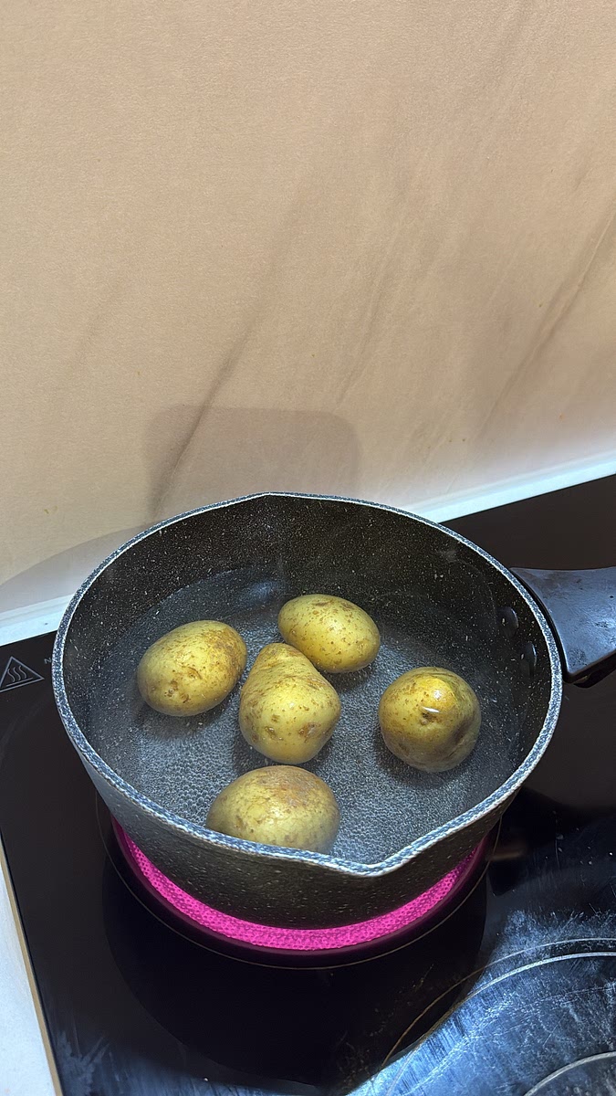 Add the baby potatoes to a saucepan of salted boiling water. Cook for 12–15 minutes until fork-tender but still holding their shape. Drain and set aside.