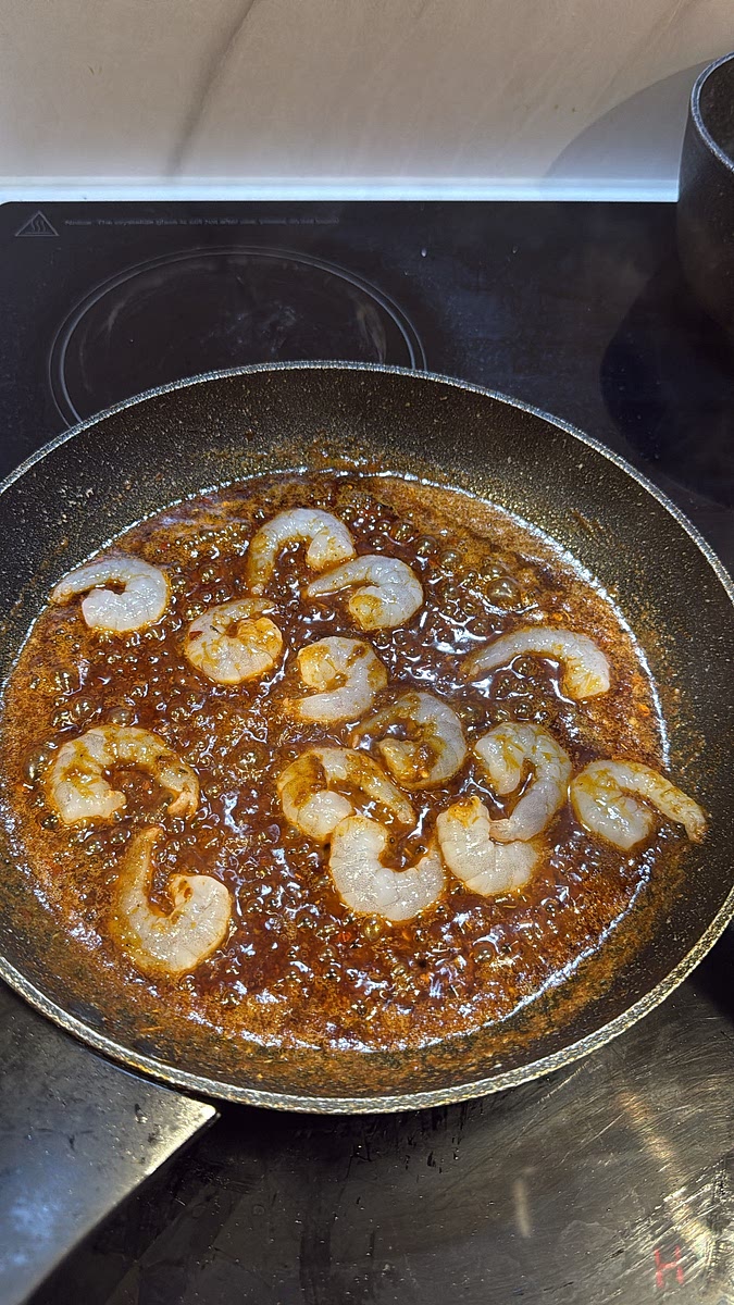 Add the prawns directly into the Creole butter sauce. Cook for approximately 2–4 minutes total, turning halfway, until they’re pink and just cooked through.