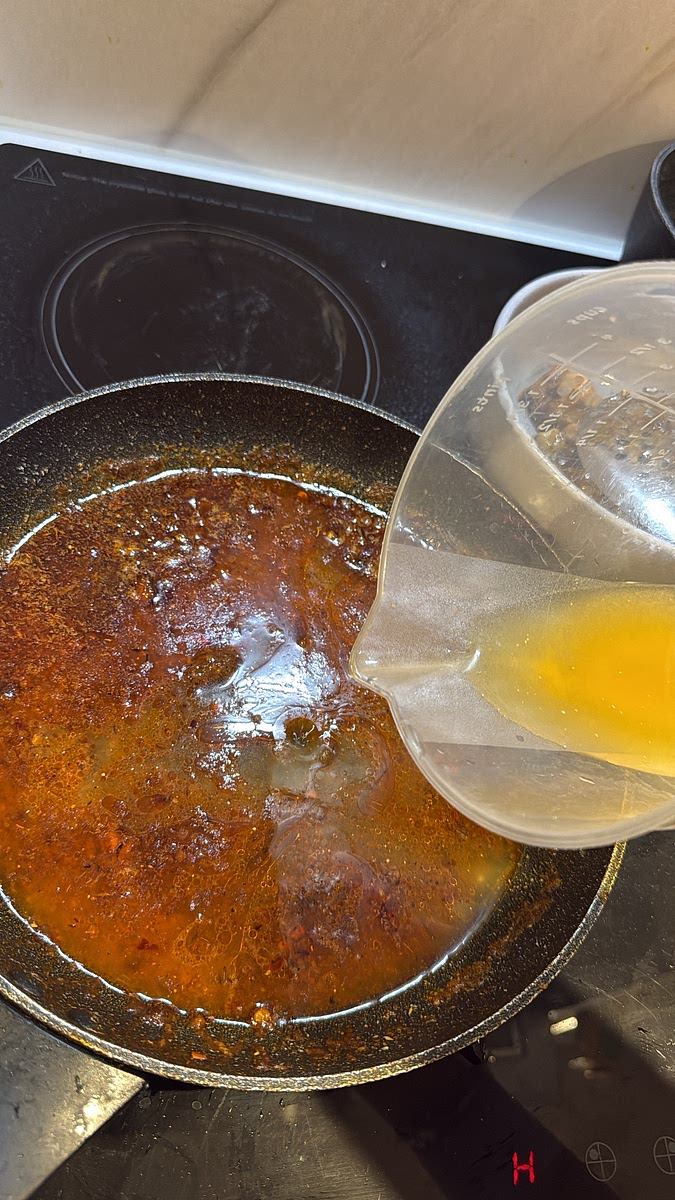 Pour in the 150ml chicken stock. Stir everything together Let the sauce gently bubble for 2–3 minutes. It should start looking glossy and slightly reduced but still have plenty of liquid for our noodles.