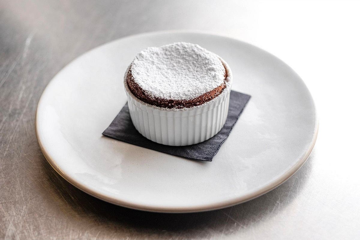 Serve immediately
Dust lightly with powdered sugar if desired. Bring the soufflés straight to the table while they're tall and airy. They will begin to deflate within minutes, which is completely normal.