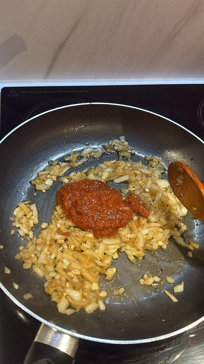 Add the Thai red curry paste and stir continuously for 1–2 minutes, allowing the flavours to develop and the paste to become fragrant.