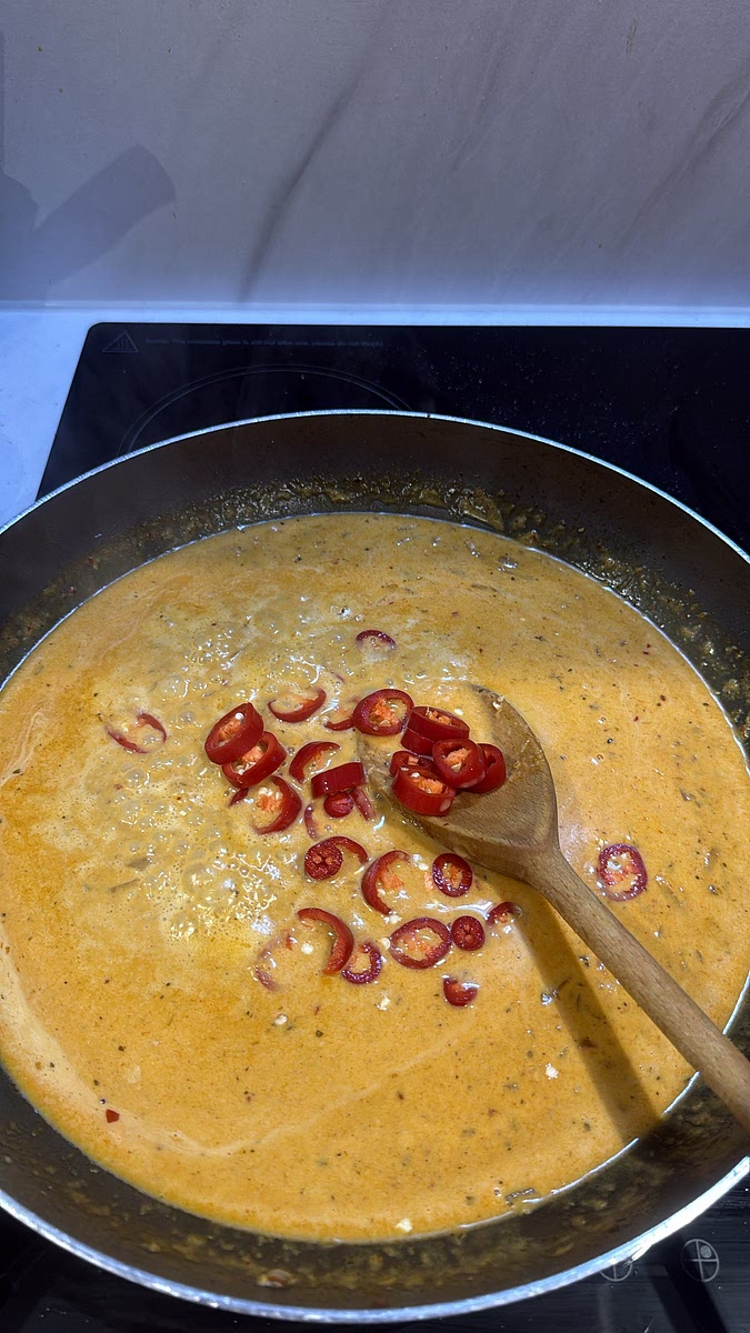 Add the water, brown sugar and sliced red chillies. Stir well and bring to a gentle simmer. Add salt to taste