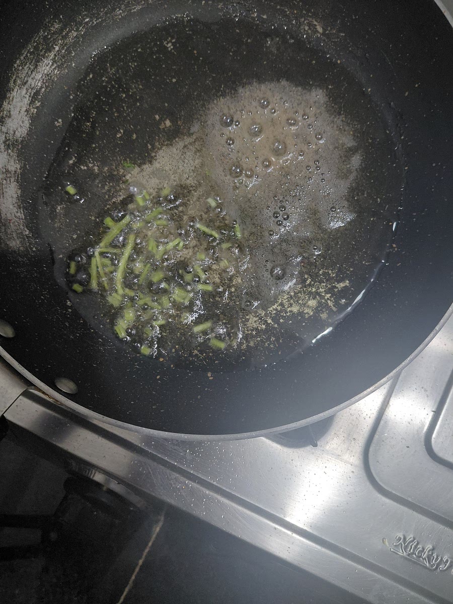 Add oil to pan. Add mustard seeds, stems of corriender and hing.