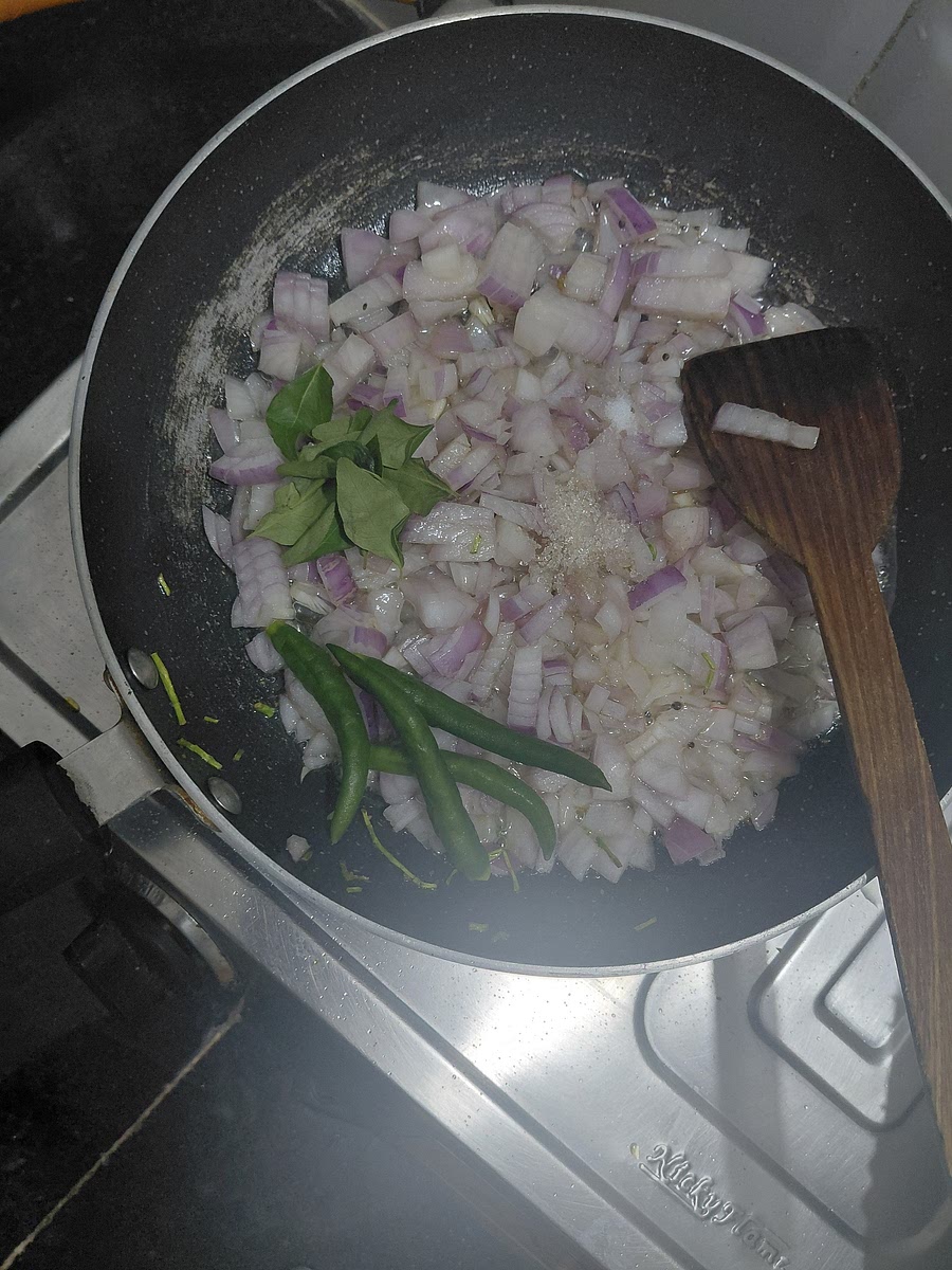 Once the mustand seeds splutters, add onions, curry leaves, chillies, 1/2 teaspoon sugar and a pinch of salt. Saute till the onions soften and become translucent.