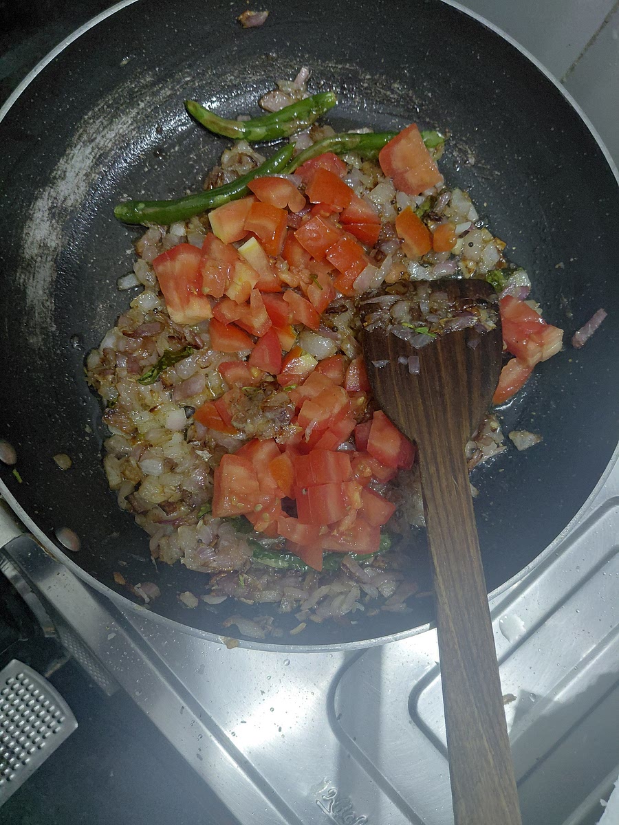 Add tomatoes and a pinch of salt.