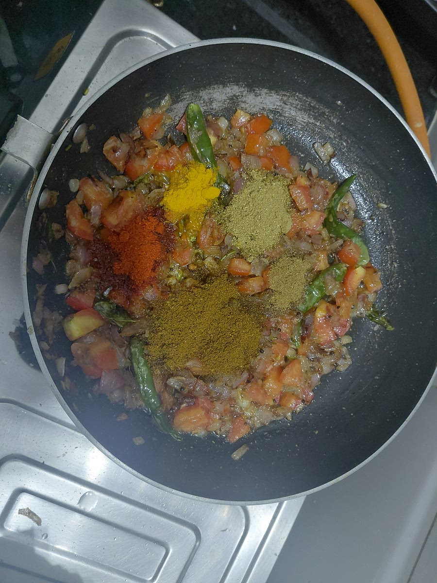 Once the tomatoes are soft. Add 1 teaspoon of turmeric and cumin powder. 1 and 1/2 teaspoon of corriender powder. 2 teaspoons of kashmiri red chilli powder. 3 teaspoons of goda masala. Mix and saute for 1 min. At this stage if required add 1 tablespoon of oil.