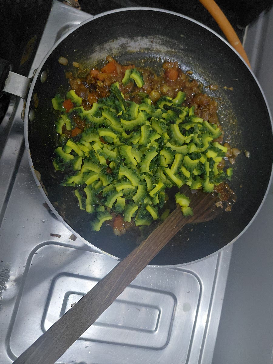 Add karela and mix well.