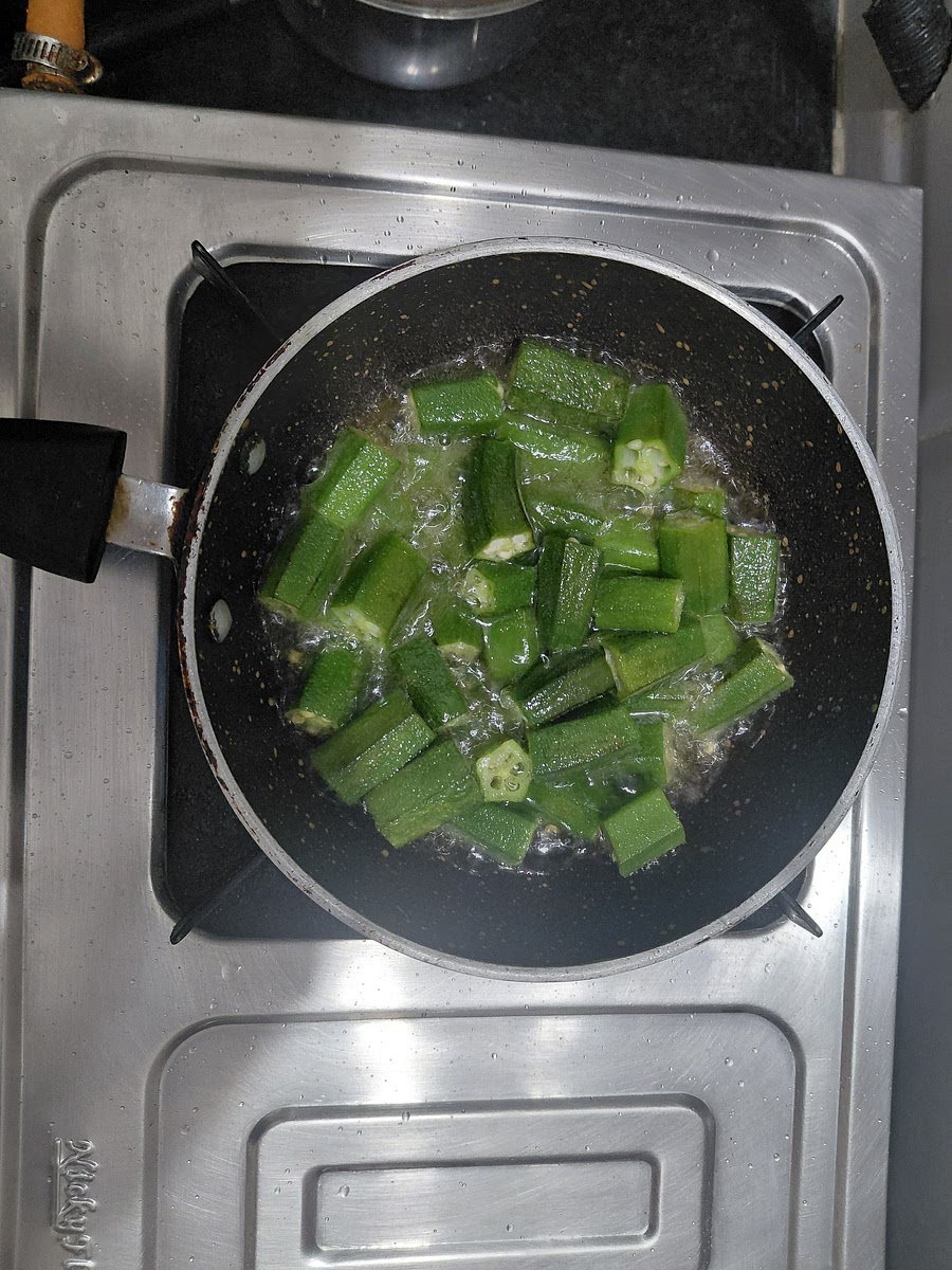 Fry bhindi till its half cooked.