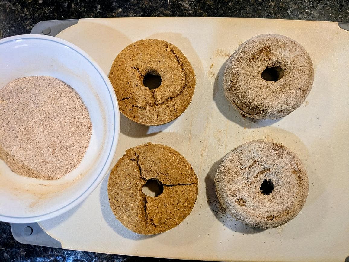 In a small bowl, whisk together your sweetener and cinnamon to make your cinnamon sugar. Lightly coat each cooled donut in cinnamon sugar, about 1 tbsp (7 g) each. Store in the fridge.