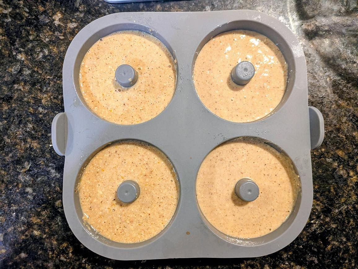 Evenly divide the donut batter across the 4 donut molds, about 95 g each.