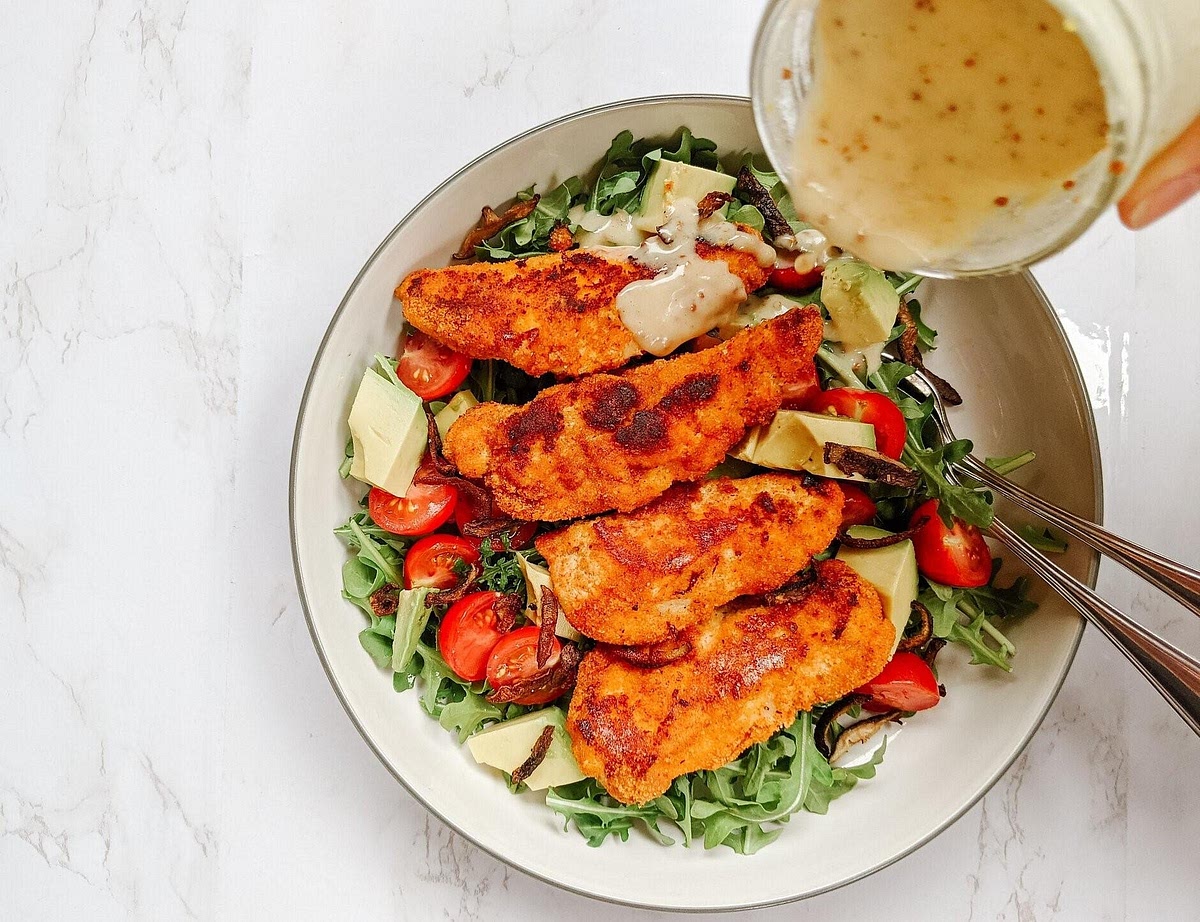 Assemble. Divide the lettuce and vegetables between two large bowls. Add quinoa, boiled egg and avocado. Top with warm crispy chicken and drizzle over the honey-mustard dressing.