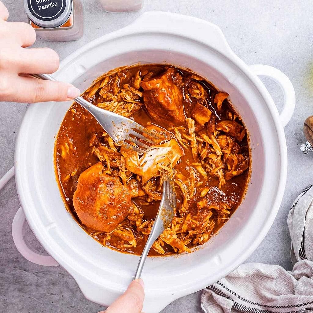Slow cook the BBQ chicken. Combine the spice rub and coat the chicken breasts. Mix the BBQ sauce ingredients in the slow cooker, add the chicken and turn to coat. Cook on low for approximately 6–7 hours or high for around 3 hours, checking for an internal temperature of 74°C. Shred with two forks and stir back into the sauce. Add a splash of water if the sauce becomes too thick.