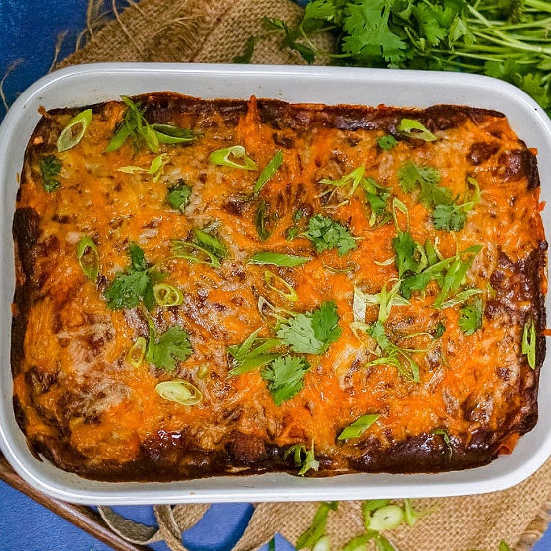 Add sauce and bake Spoon enough of the remaining enchilada sauce over the tortillas to cover them generously without leaving a deep pool of liquid. Reserve any excess for serving. Sprinkle dairy-free cheese over the top, or drizzle with cashew queso. Bake uncovered for approximately 15–20 minutes, until the sauce is bubbling and the filling is piping hot.