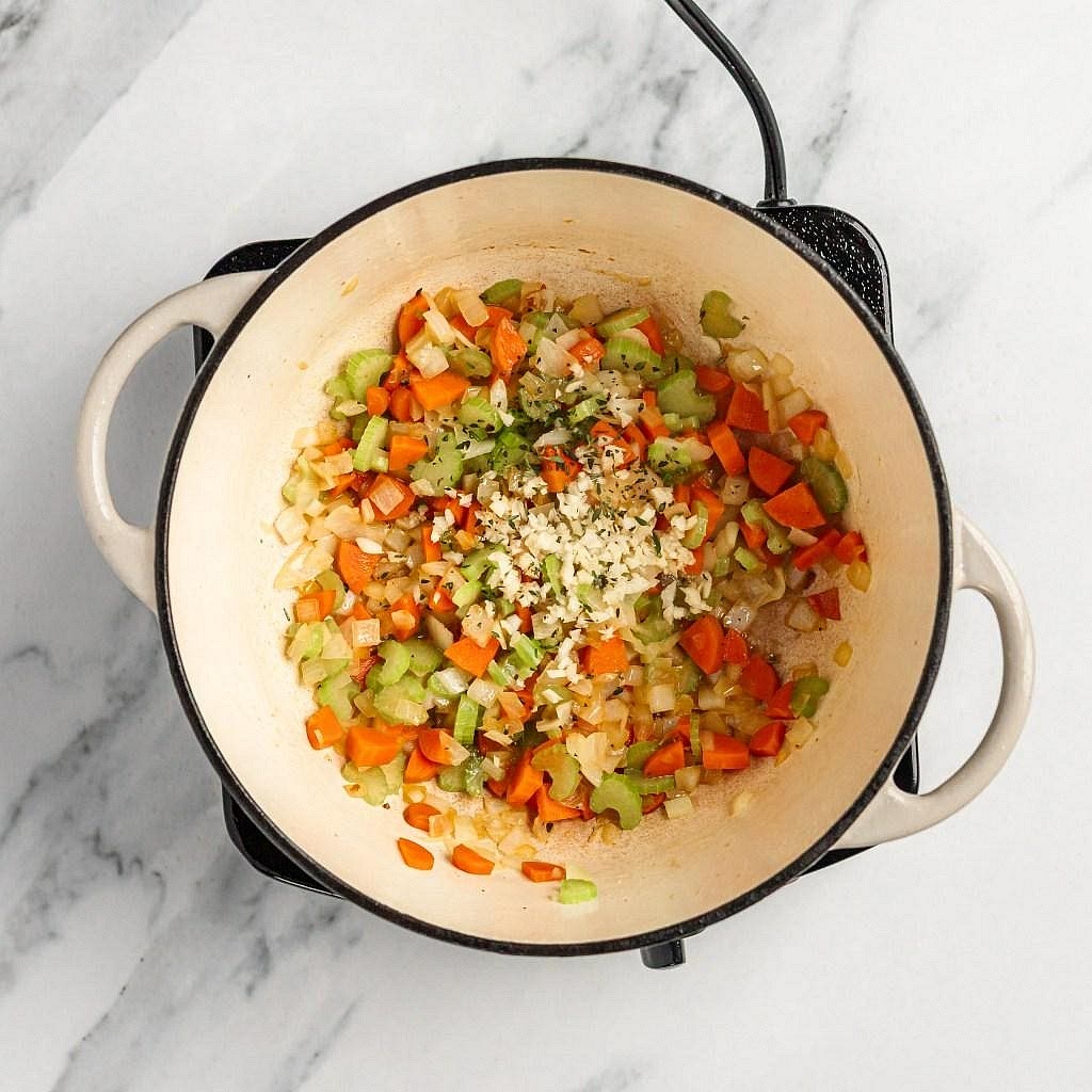 Sauté the vegetables Add the diced onion, celery and carrots to the Instant Pot. Cook for approximately 3–5 minutes until the onion softens. Add the garlic and courgette and sauté for another minute. These vegetables create a naturally sweet, savoury foundation for the broth.