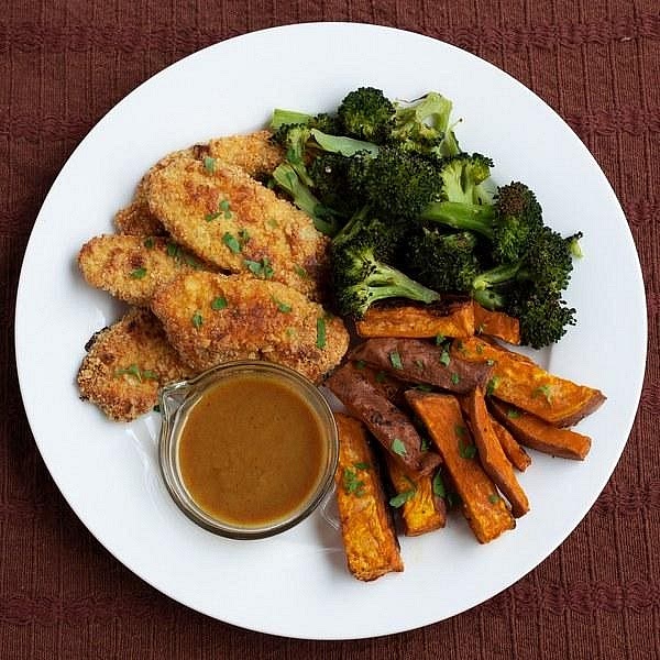 Assemble your dinner Divide the crispy chicken tenders between two plates. Add a generous serving of roasted broccoli, carrots and chickpeas alongside the golden sweet potato wedges. Serve the creamy honey-mustard sauce on the side for dipping.