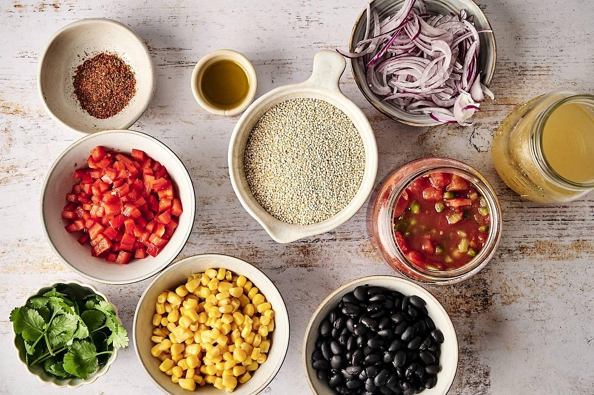 Prepare the casserole ingredients Rinse the quinoa thoroughly under cold running water. Drain and rinse the black beans and sweetcorn. Dice the red pepper and onion. Keep the courgette and baby spinach aside because they are best added towards the end of cooking.