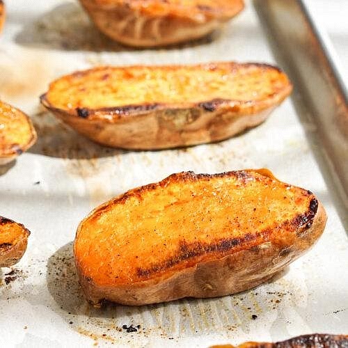 Roast the sweet potatoes Preheat your oven to 200°C. Wash and dry the sweet potatoes. Cut each lengthwise and lightly brush the cut surfaces with olive oil. Sprinkle with smoked paprika, salt and black pepper. Place cut-side down on a lined baking tray and roast for approximately 30–40 minutes until the flesh becomes tender and the edges lightly caramelise. Larger potatoes may require additional cooking time.