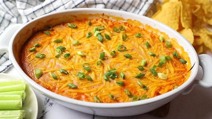 Bake the buffalo chicken filling Once the potatoes are nearly tender, reduce the oven temperature to 180°C. Transfer the buffalo chicken mixture into a lightly greased, small ovenproof dish. Bake for approximately 18–20 minutes until hot and bubbling around the edges. The filling should be thick enough to scoop, with a creamy, slightly golden surface. If using leftover cooked chicken, reheat the filling thoroughly to 74°C.