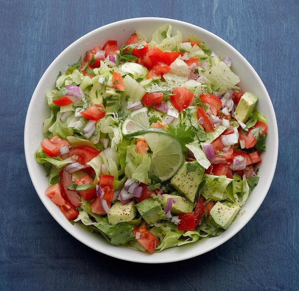 Prepare the rainbow salad Combine shredded lettuce, cherry tomatoes, diced cucumber, finely chopped red onion and coriander. Toss with fresh lime juice just before serving. Keep the salad crisp and refreshing. Its acidity balances the smoky, warm fajita filling.