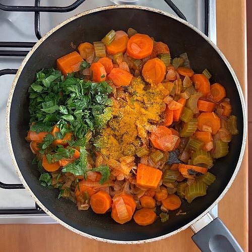 Add the ginger, turmeric and herbs Stir in the grated ginger, turmeric, rosemary, thyme, salt and black pepper. Cook for approximately 1 minute, stirring continuously to prevent the spices from burning. The turmeric should give the vegetables a warm, golden-yellow colour, while the ginger adds a subtle peppery warmth.