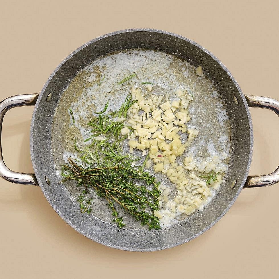 Make the garlic-herb sauce Reduce the heat to low and add the dairy-free butter to the same pan. Once melted, add the minced garlic, rosemary and thyme. Stir gently for approximately 30–60 seconds, until fragrant. Avoid letting the garlic brown too much. Return the steak and any resting juices to the pan and gently toss to coat in the aromatic sauce. If the sauce is too thick or the pan is dry, add a tablespoon of water.