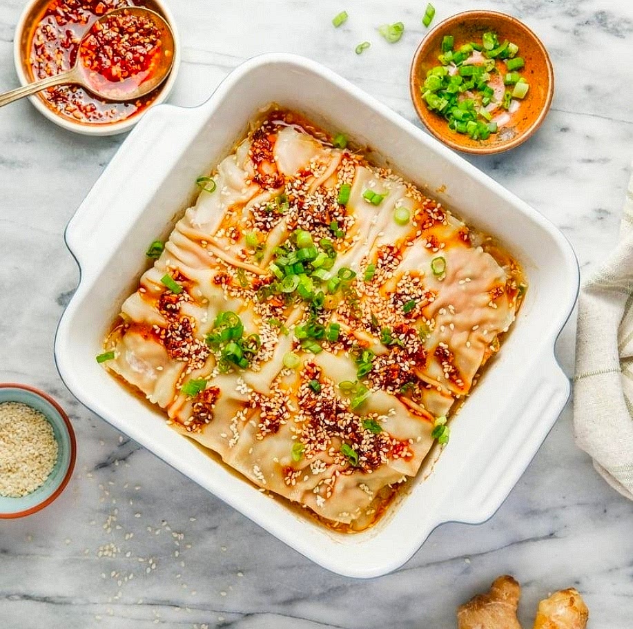 Bake
Cover tightly with foil and bake for 35–40 minutes. Remove the foil and bake another 10–15 minutes, until the wrappers are tender and the pork reaches 160°F in the center.
Let rest for 10 minutes before cutting into squares. Garnish with green onions and sesame seeds.