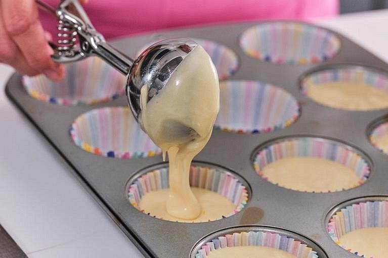 Preheat your oven to 180°C conventional or 160°C fan. Line a 12-hole muffin tin with paper cases. Divide the batter evenly between them, filling each case about two-thirds to three-quarters full.